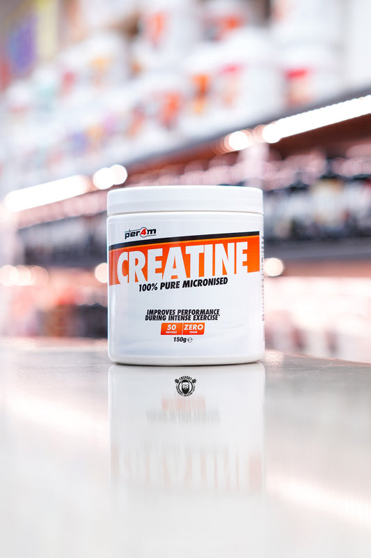 Per4m Creatine Monohydrate 150g tub, 100% pure micronised creatine with 50 servings and zero sugar, displayed on supplement store counter.