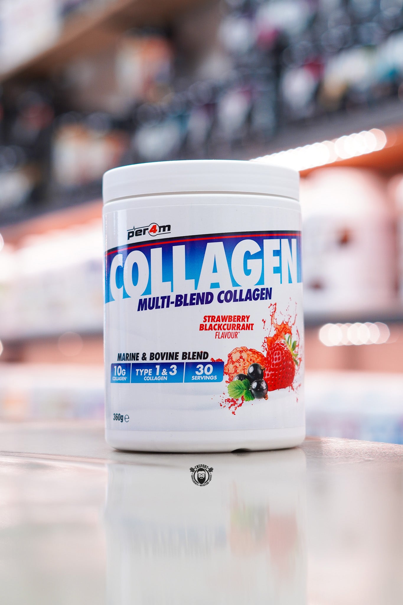 Per4m Multi-Blend Collagen powder, Strawberry Blackcurrant flavour, featuring marine and bovine collagen with 10g collagen per serving, displayed on a supplement store counter.