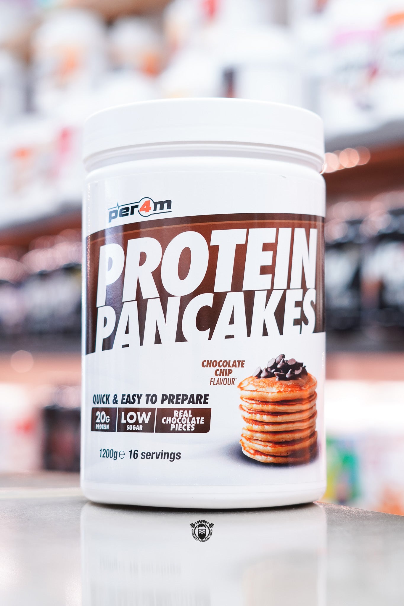 White tub of Per4m Protein Pancakes, Chocolate Chip flavour, with pancakes and chocolate chips pictured on the label.
