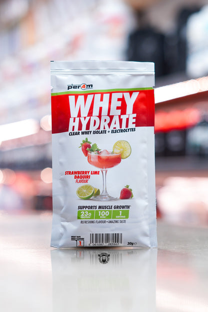 Per4m Whey Hydrate 30g sample sachet, Strawberry Lime Daiquiri flavour, clear whey isolate with electrolytes, displayed on counter in supplement store.