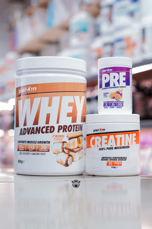 Per4m supplement bundle featuring 900g Whey Advanced Protein S’mores flavour (30 servings), Creatine Monohydrate 150g (50 servings), and Pre Advanced Pre-Workout Passion Fruit flavour, displayed on supplement store counter.