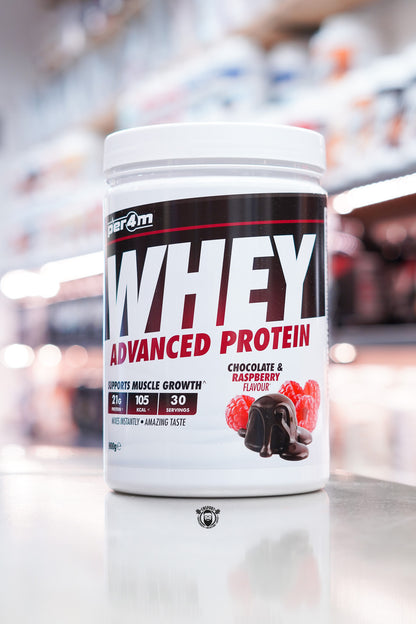 Per4m Whey Advanced Protein powder tub, Chocolate & Raspberry flavour, 900g, displayed on supplement store counter.