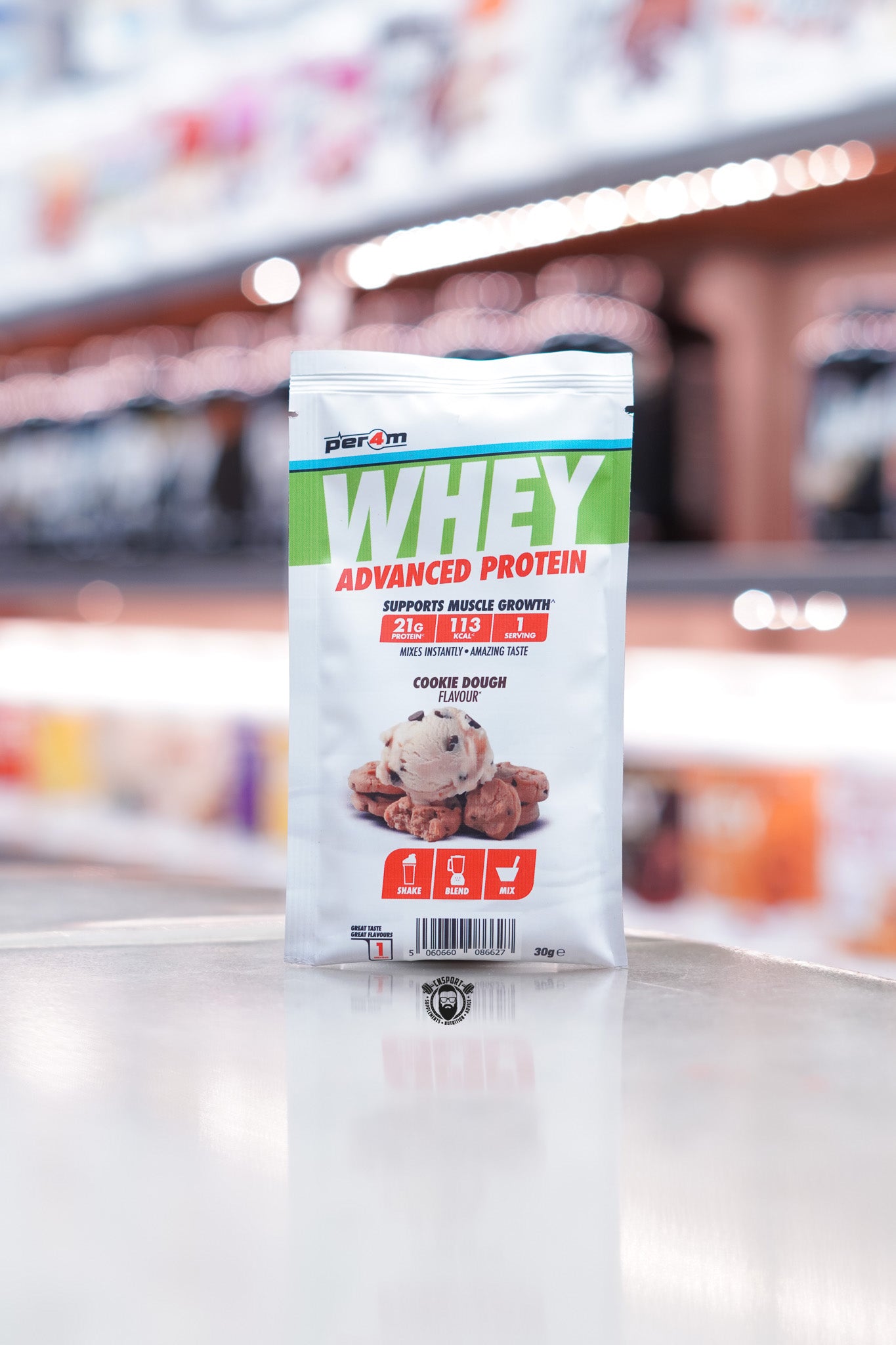 Front of a Per4m Whey Advanced Protein sample pouch in Cookie Dough flavour, showing 21g protein, 113 kcal, and 1 serving. Includes an image of cookie dough and red shake/blend/mix icons.