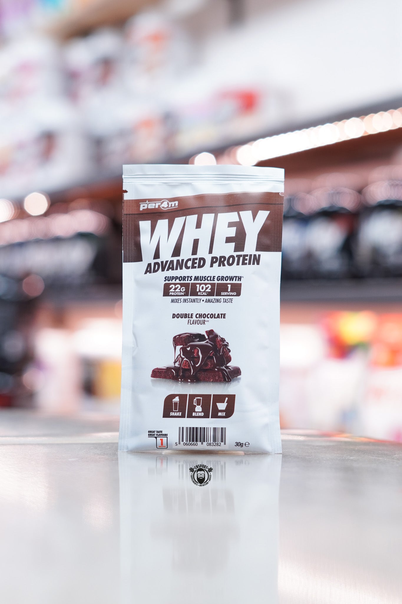 Small pouch of Per4m Advanced Whey protein powder, Double Chocolate flavour. The front features rich chocolate brownie pieces, highlighting 22g protein, 102 kcal, and 1 serving per pack.