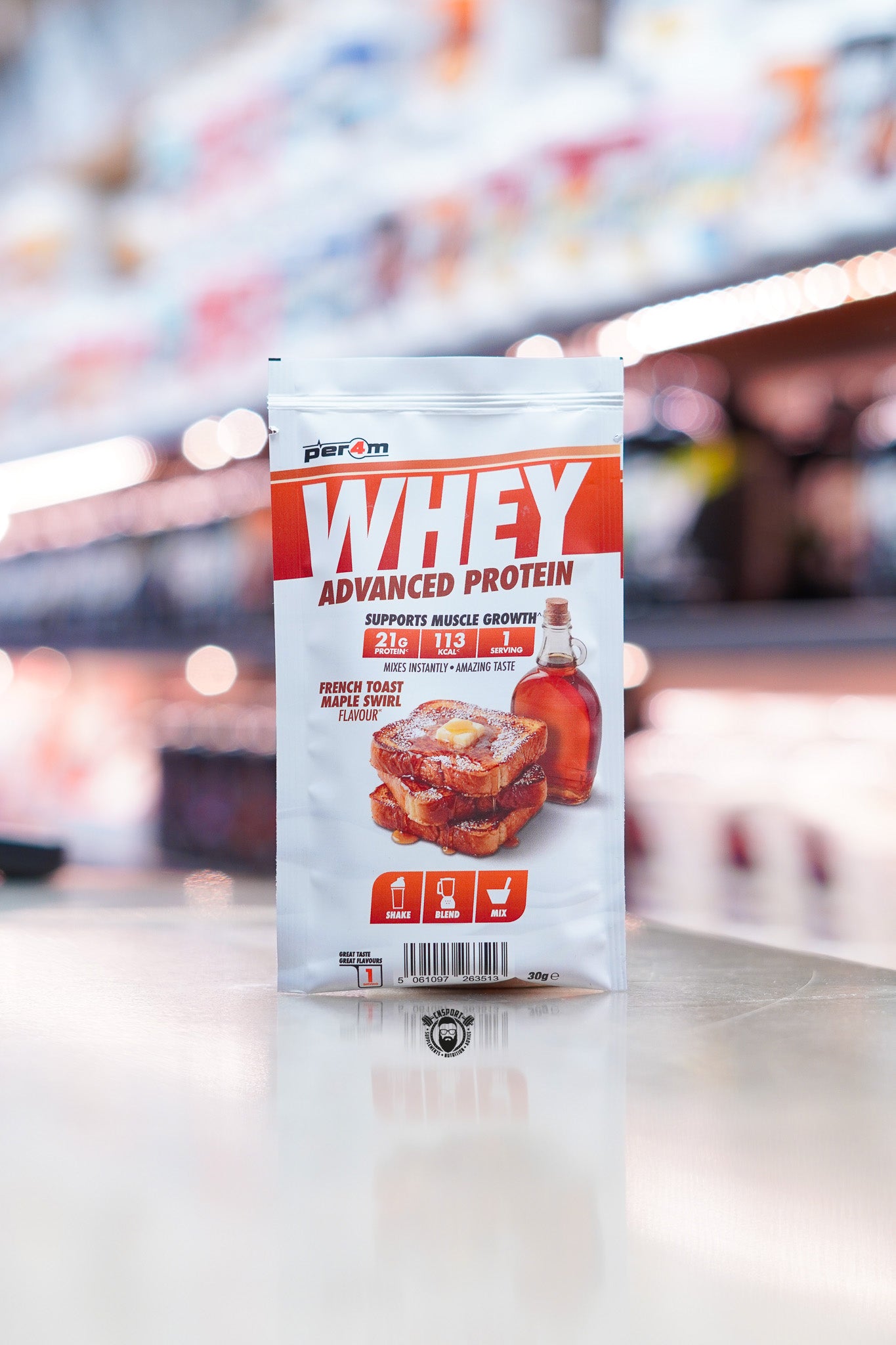 Per4m Advanced Whey Protein sample sachet, French Toast Maple Swirl flavour, displayed on supplement store counter.