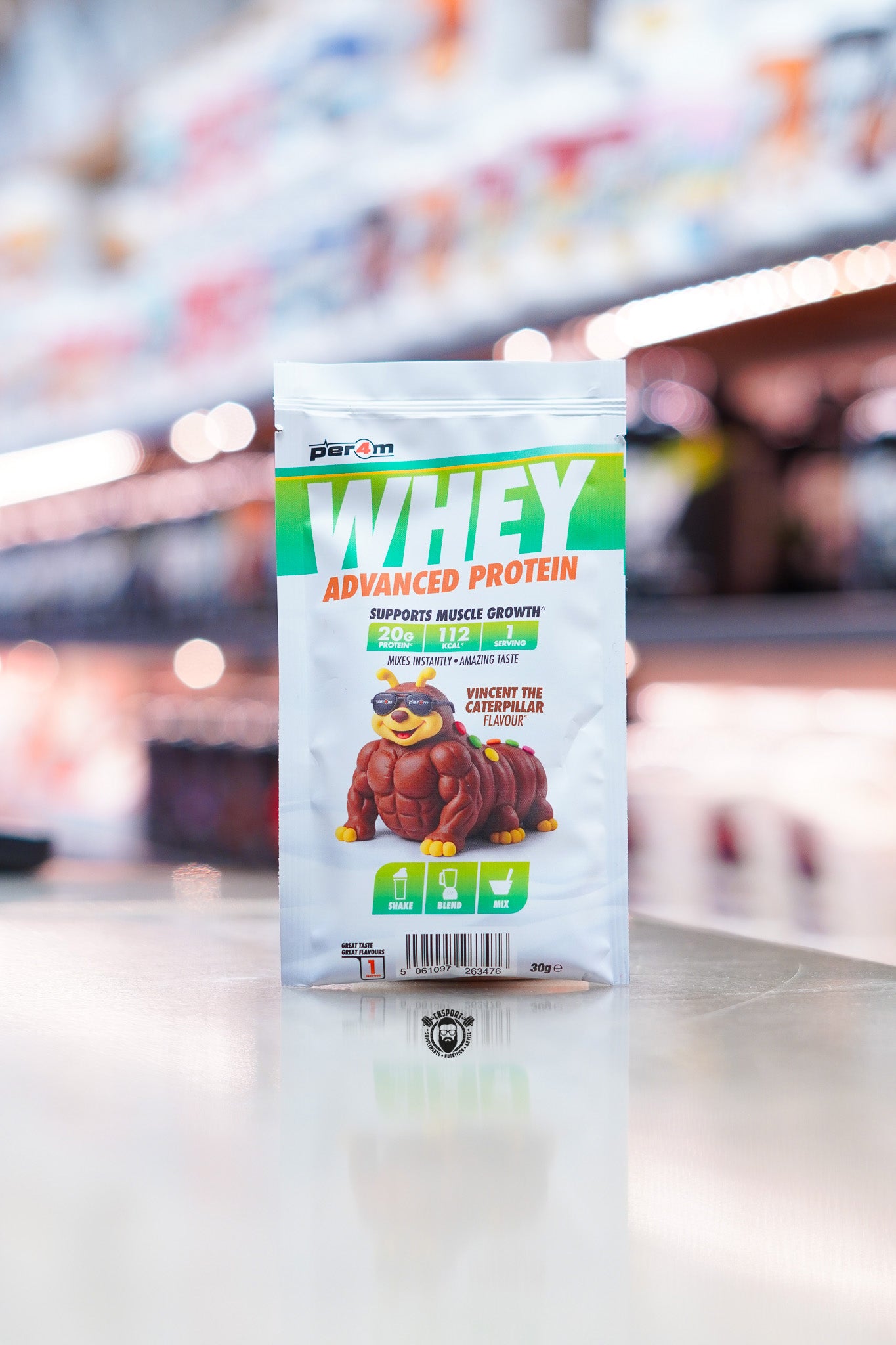 Per4m Advanced Whey Protein sample sachet, Vincent the Caterpillar flavour, displayed on supplement store counter.