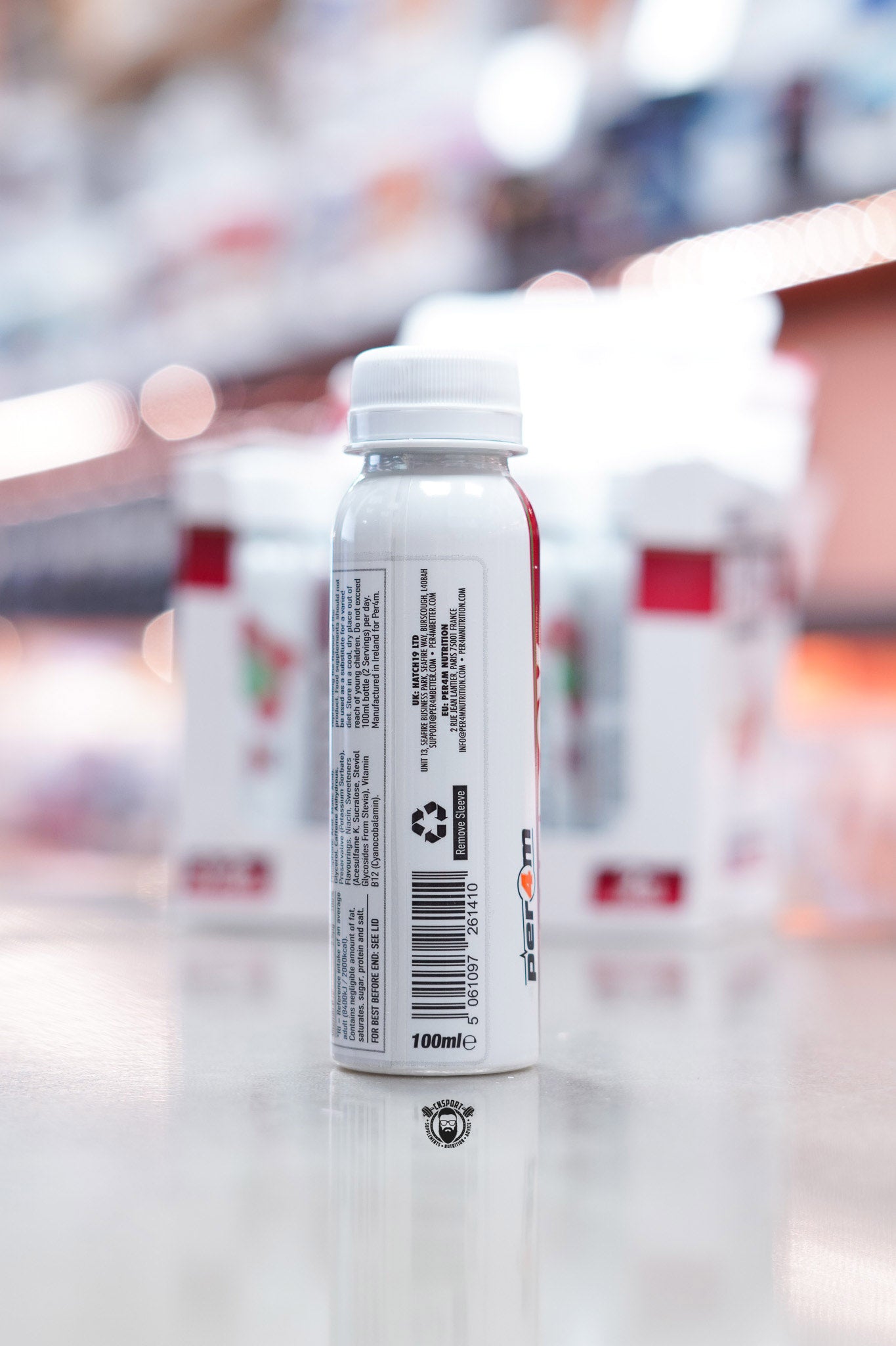 Side view of Per4m Energy Pre-Workout Shot Cherry Fizz bottle displaying barcode, recycling label, and manufacturer information.