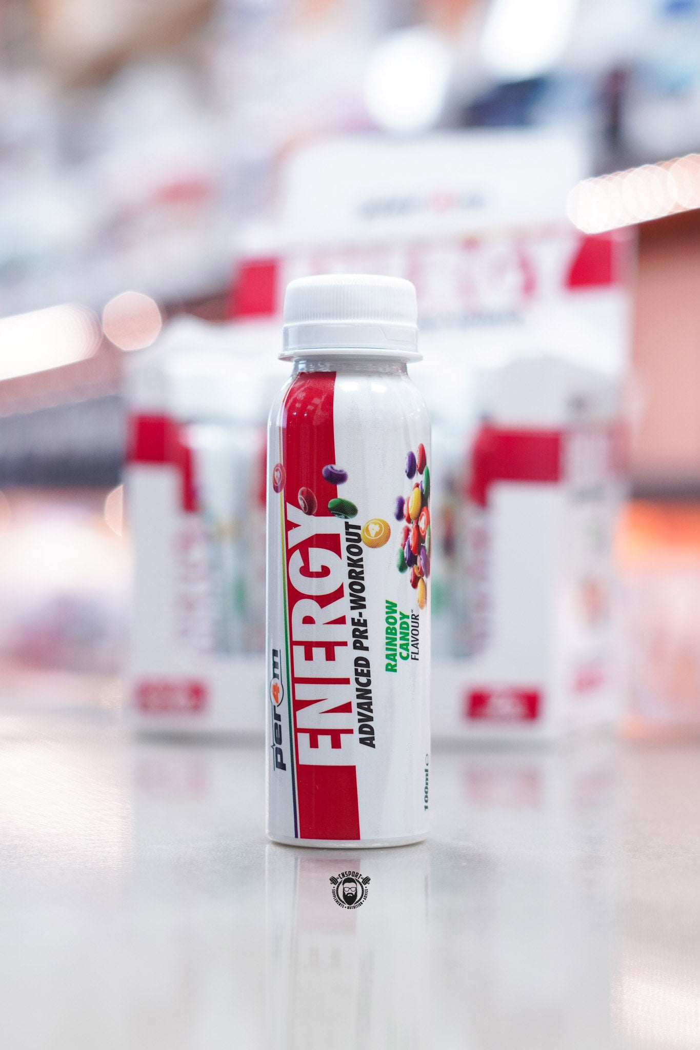 Front-facing image of Per4m Energy Pre-Workout Shot Rainbow Candy flavour bottle with bright rainbow candy visuals and red label accent.