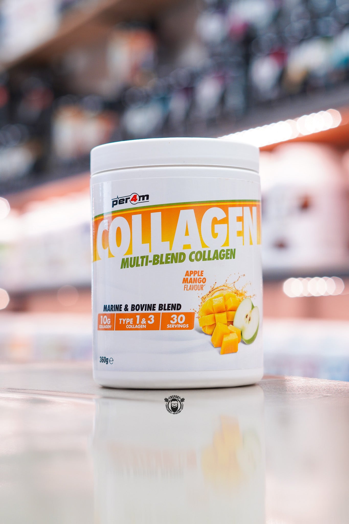 Per4m Multi-Blend Collagen powder, Apple Mango flavour, featuring marine and bovine collagen with 10g collagen per serving, displayed on a supplement store counter.