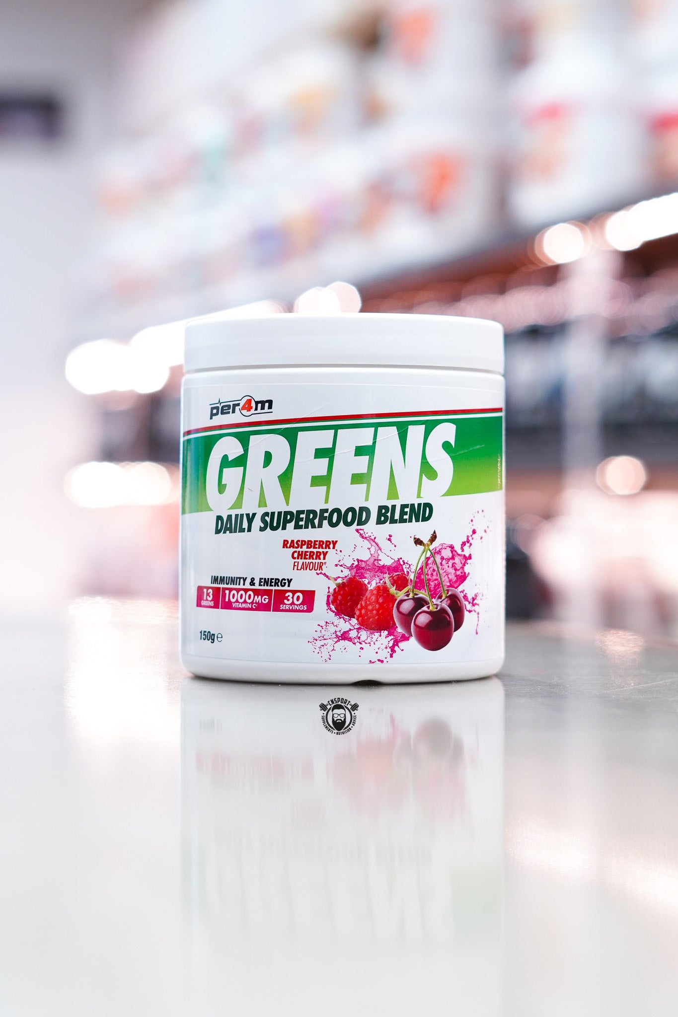Per4m Greens daily superfood blend powder, raspberry cherry flavour, 30 servings tub on supplement store counter.