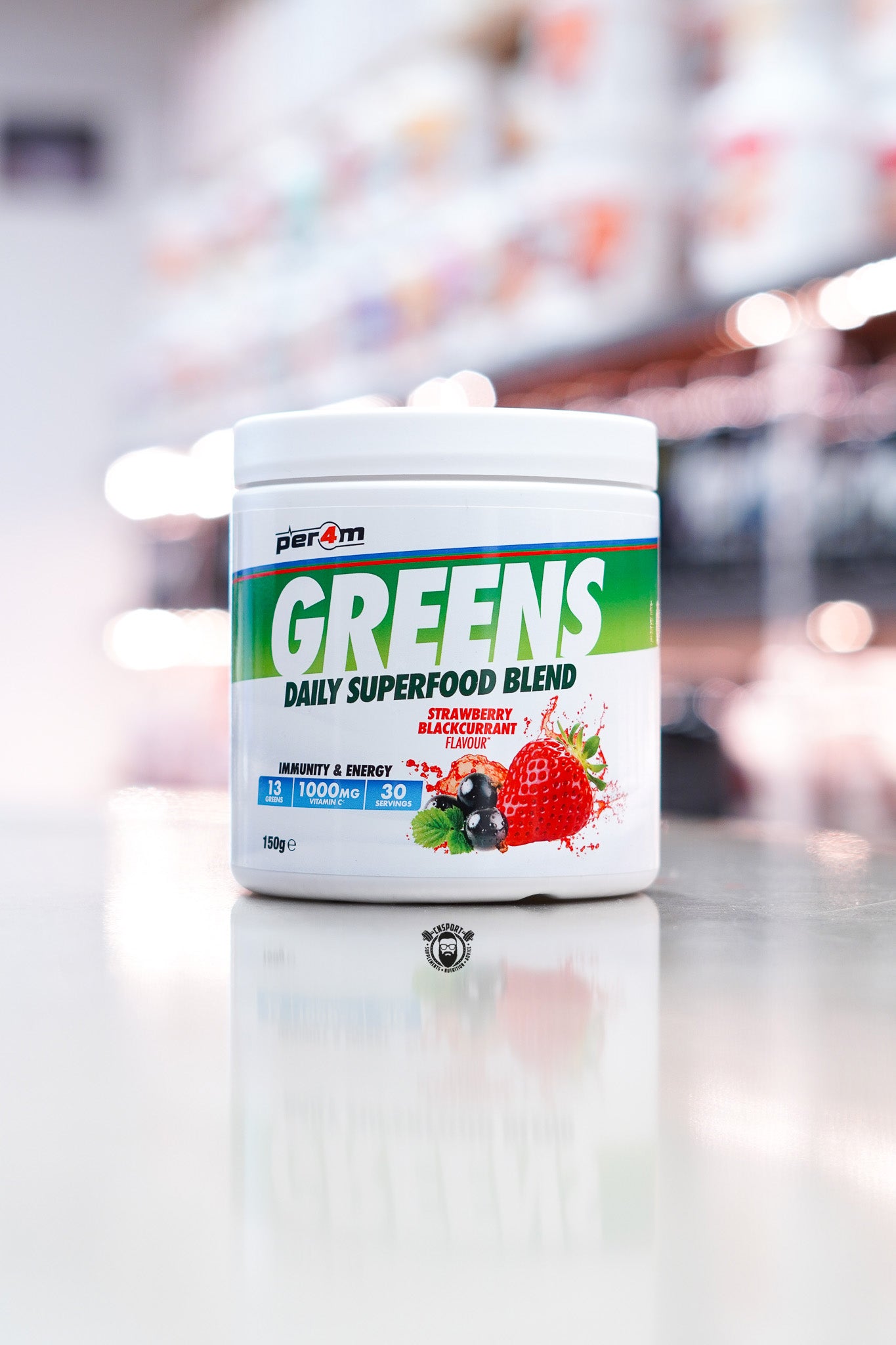 Per4m Greens daily superfood blend powder, strawberry blackcurrant flavour, 30 servings tub on supplement store counter.