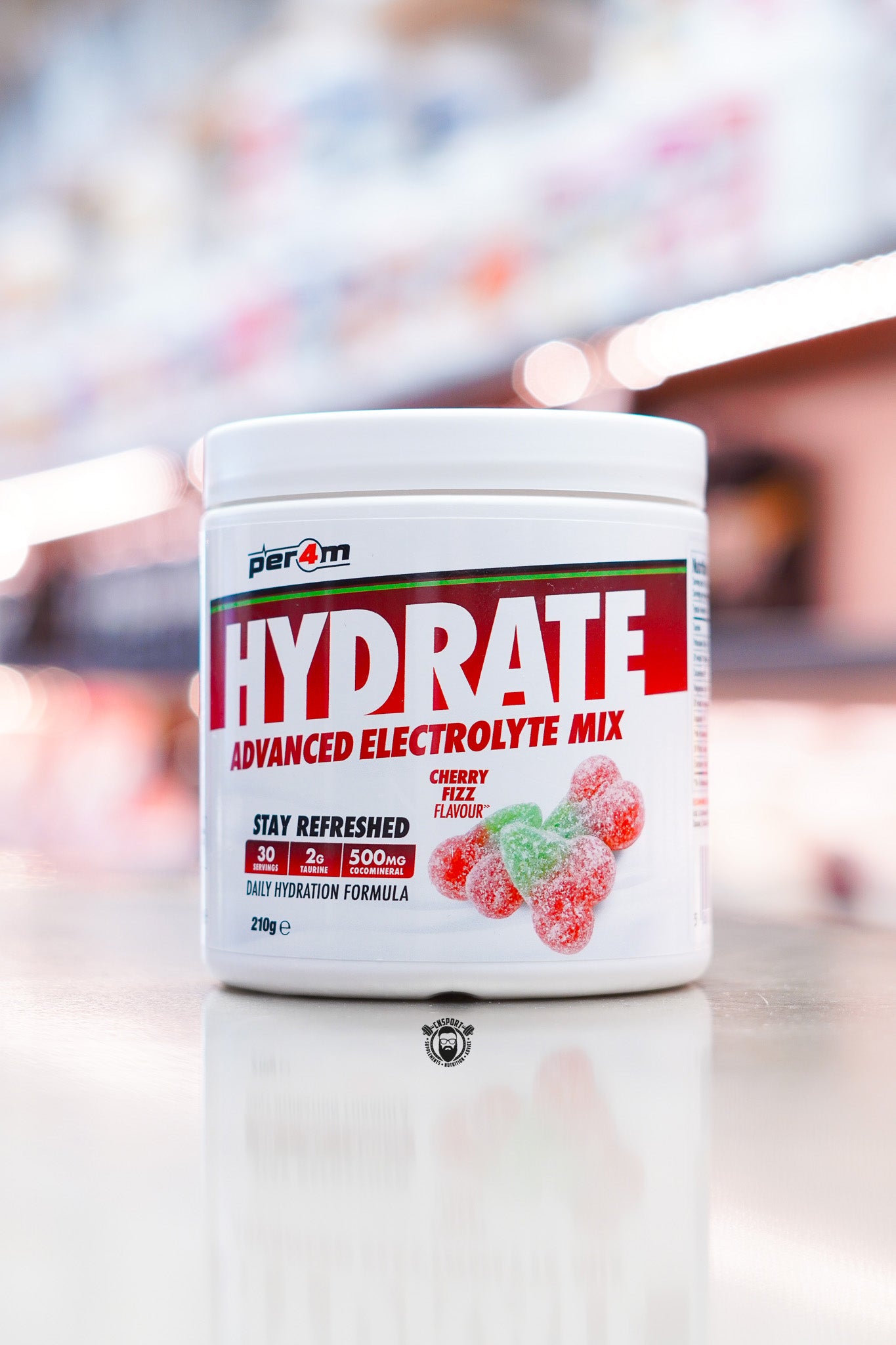 Per4m Hydrate Advanced Electrolyte Mix 210g tub, Cherry Fizz flavour, displayed on supplement store counter.