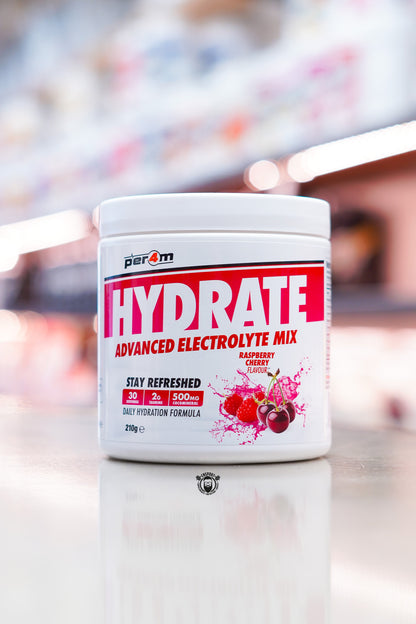Per4m Hydrate Advanced Electrolyte Mix 210g tub, Raspberry Cherry flavour, displayed on supplement store counter.