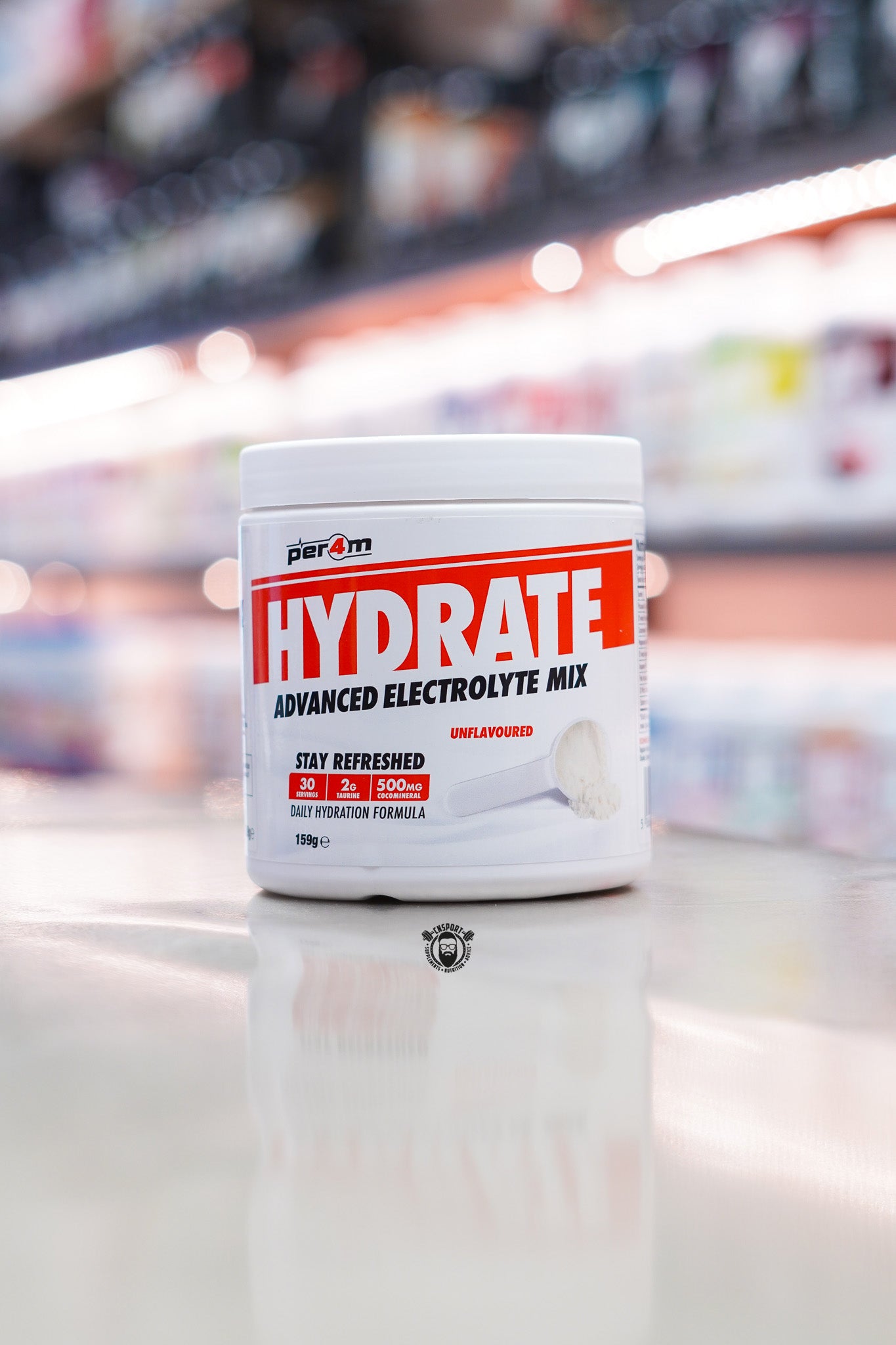 Per4m Hydrate Advanced Electrolyte Mix, unflavoured 30-serving hydration formula with taurine and coconut water, displayed on a supplement store counter.