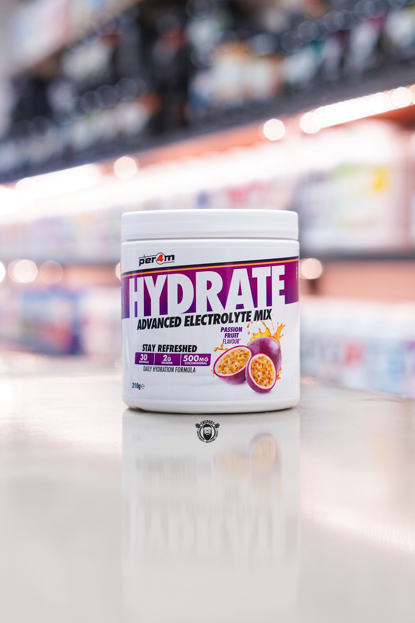 Per4m Hydrate Advanced Electrolyte Mix Passion Fruit flavour tub with 30 servings displayed on a supplement store counter.