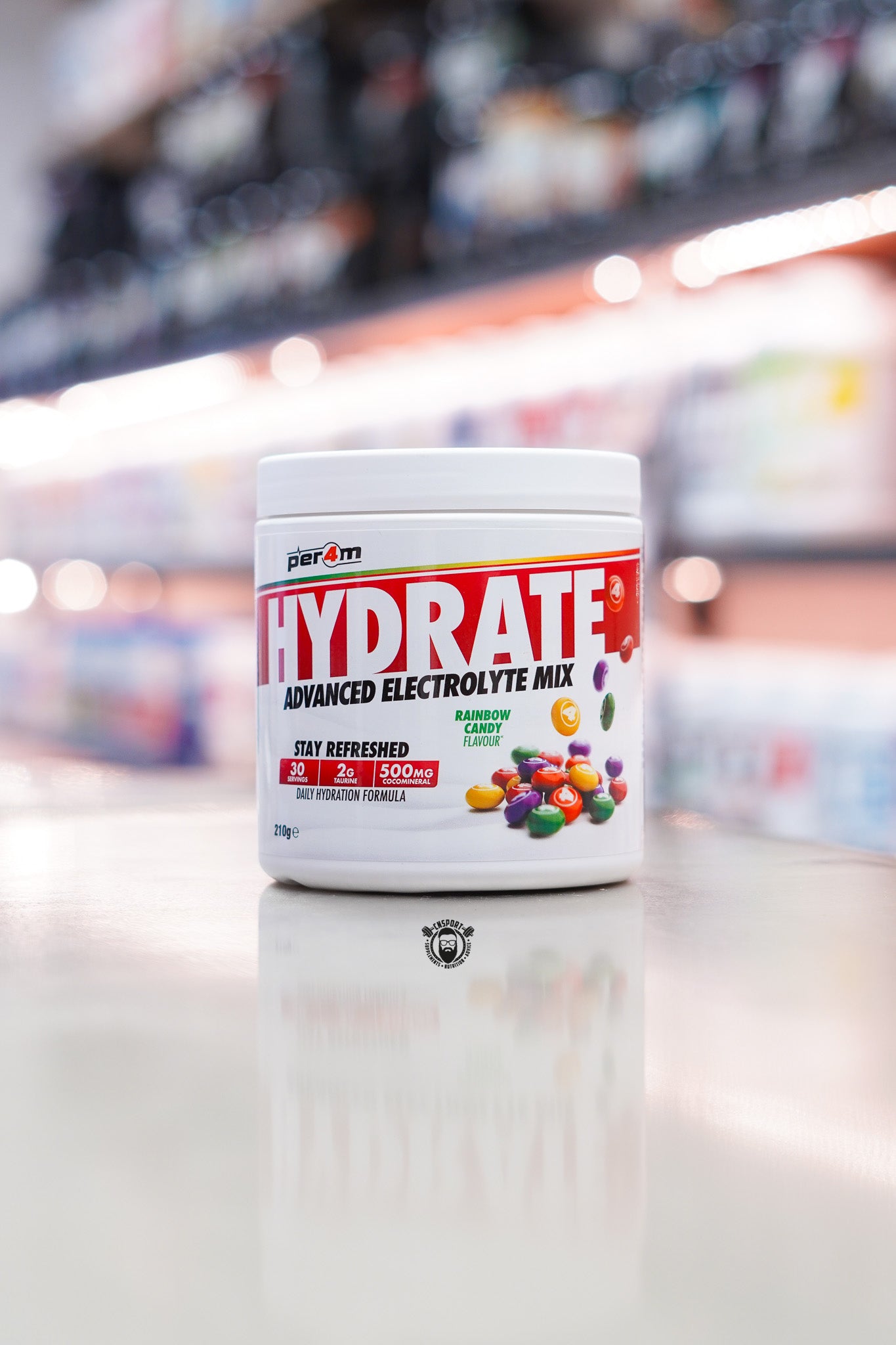 Per4m Hydrate Advanced Electrolyte Mix Rainbow Candy flavour tub with 30 servings displayed on a supplement store counter.