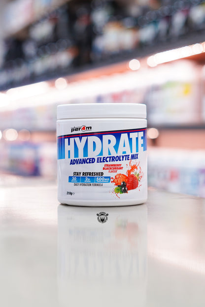 Per4m Hydrate Advanced Electrolyte Mix Strawberry Blackcurrant flavour tub with 30 servings displayed on a supplement store counter.