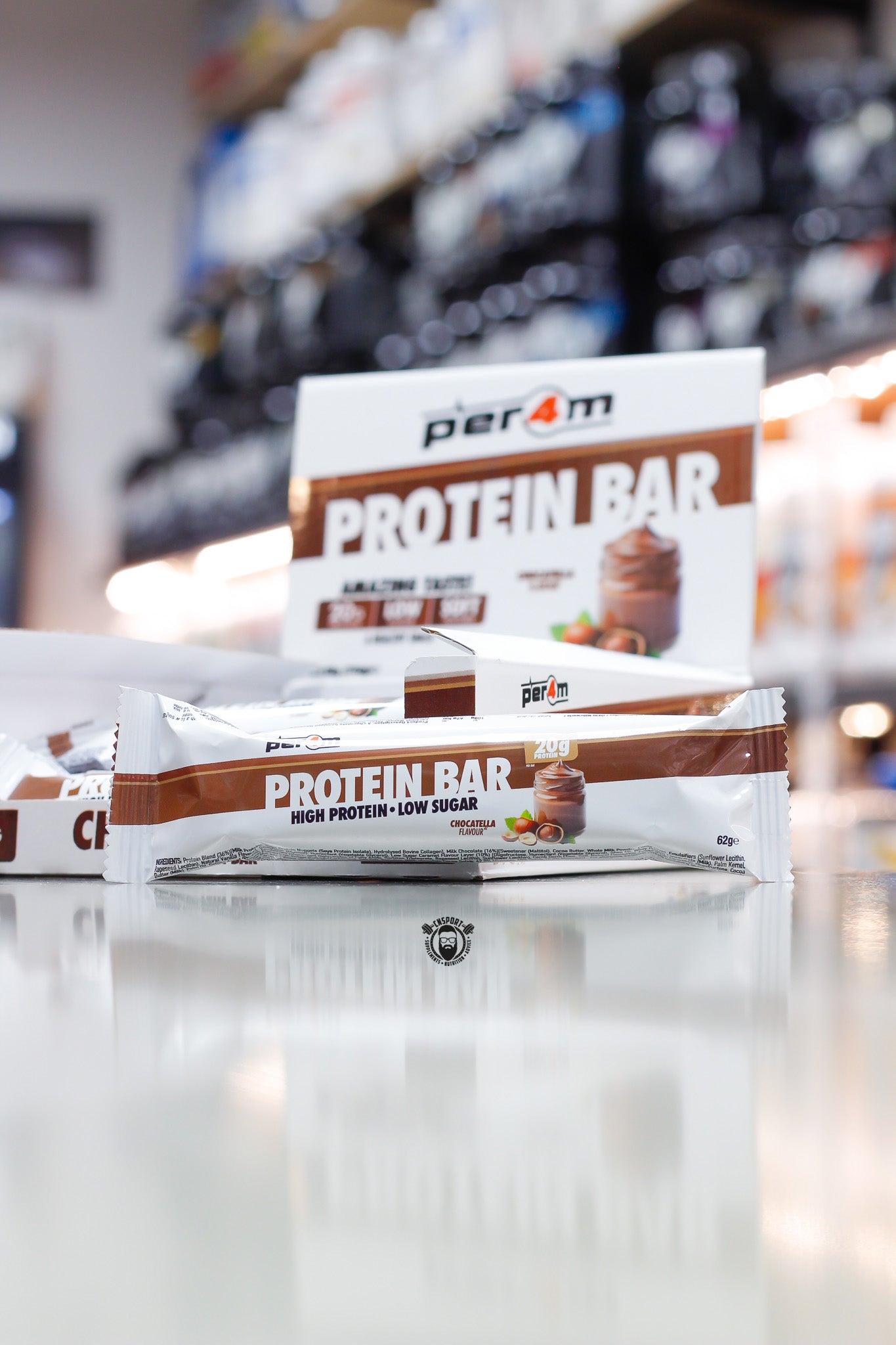 Per4m Protein Bar, Choctella flavour (20g protein), high protein low sugar bar displayed in front of open retail box in supplement store.