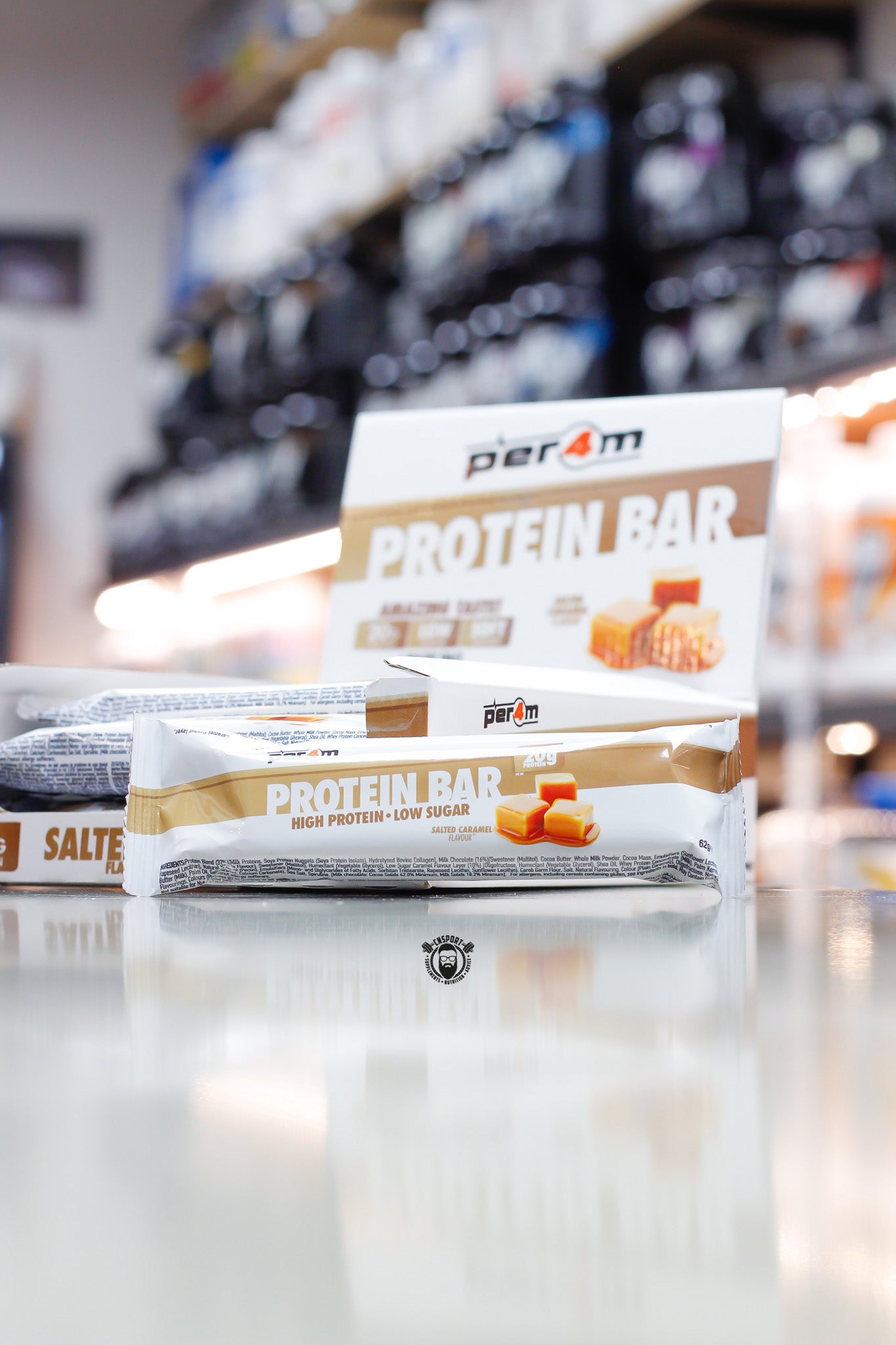 Per4m Protein Bar, Salted Caramel flavour (20g protein), high protein low sugar bar displayed in front of open retail box in supplement store.