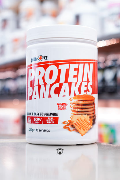 White tub of Per4m Protein Pancakes, Caramel Biscuit flavour, with image of pancakes and caramel biscuits on the label.