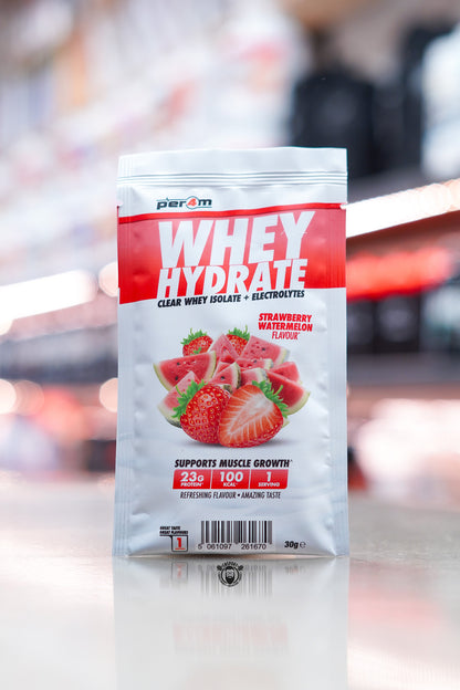 Per4m Whey Hydrate 30g sample sachet, Strawberry Watermelon flavour, clear whey isolate with electrolytes, displayed on counter in supplement store.