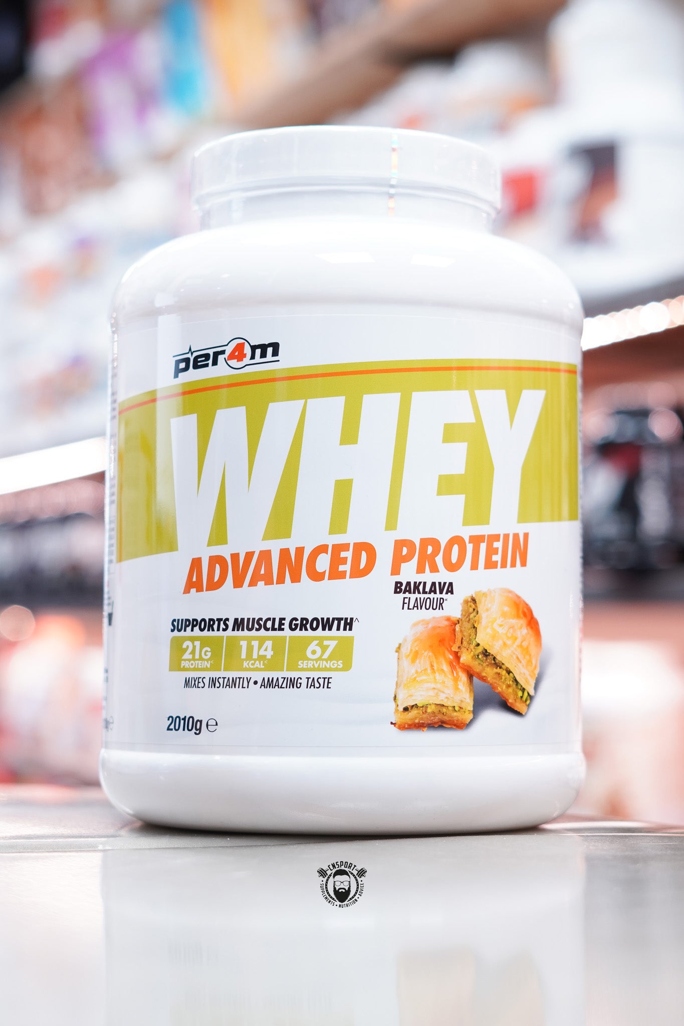 Large white tub of Per4m Whey Advanced Protein in baklava flavour, 67 servings, with baklava illustration.