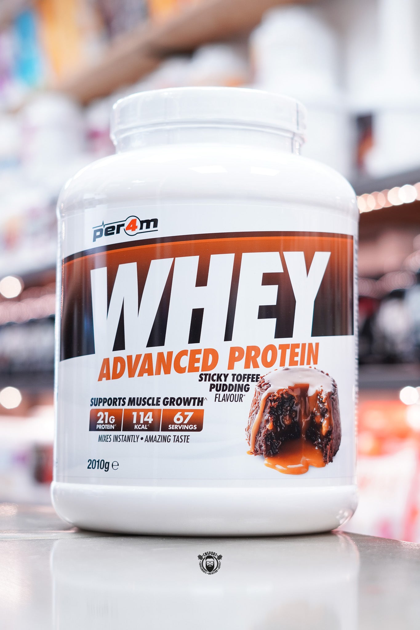 Per4m Whey Advanced Protein in Sticky Toffee Pudding flavour, 2kg tub with 67 servings, providing 21g protein and 114 calories per serving.