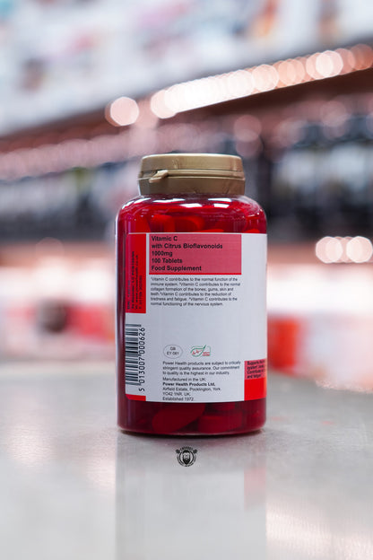 Side label showing manufacturer details, storage advice, and health benefit claims including immune system, skin, gums, bones, teeth, and reduction of tiredness and fatigue.