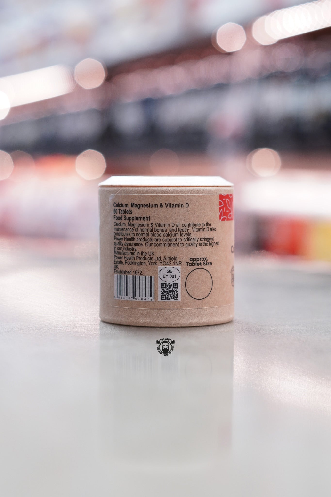 Product label showing supplement description, manufacturer details, barcode, and quality assurance information.