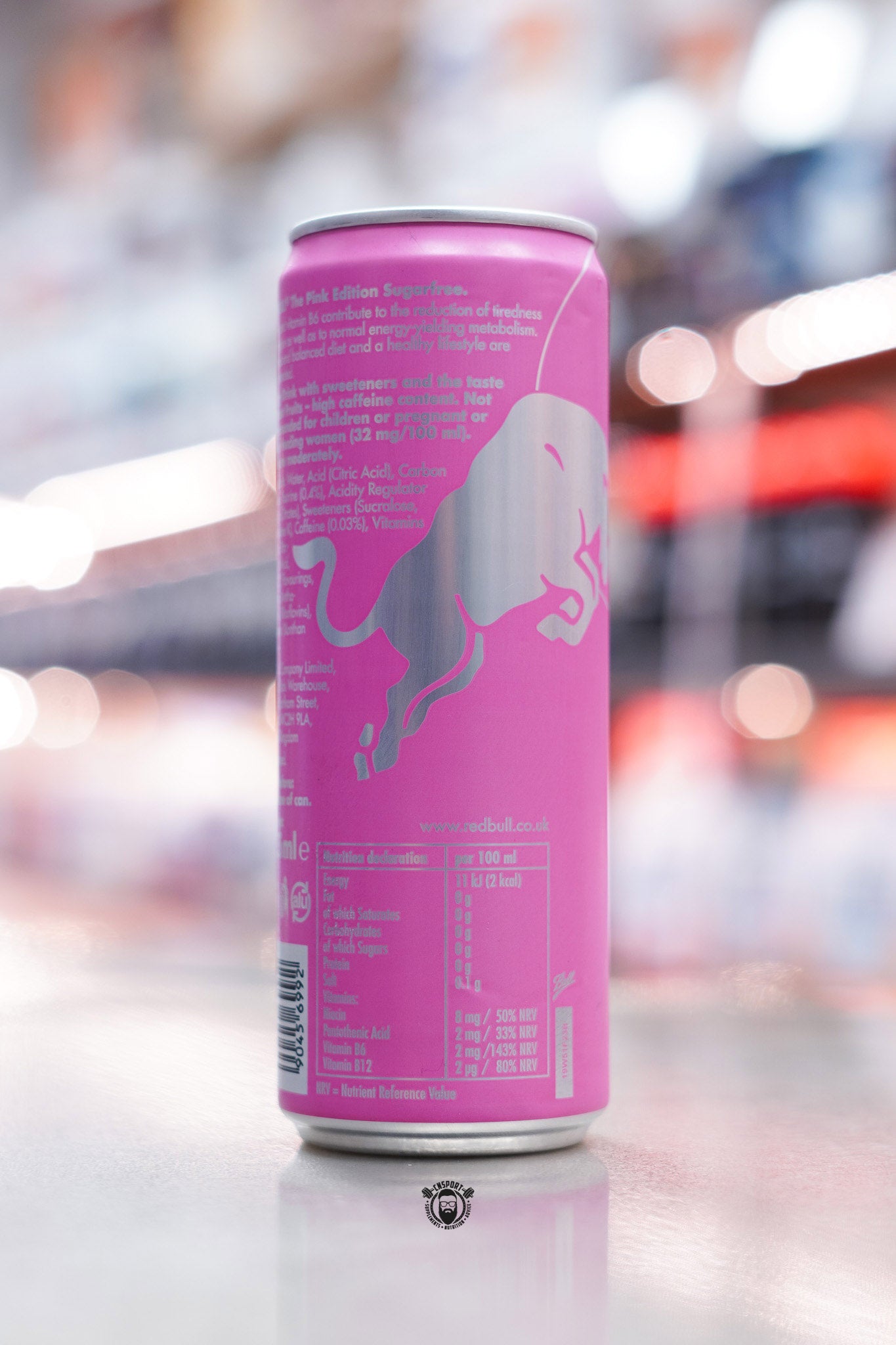 Angled rear view of Red Bull The Pink Edition Sugarfree 355ml can with pink metallic finish and detailed nutritional information panel.
