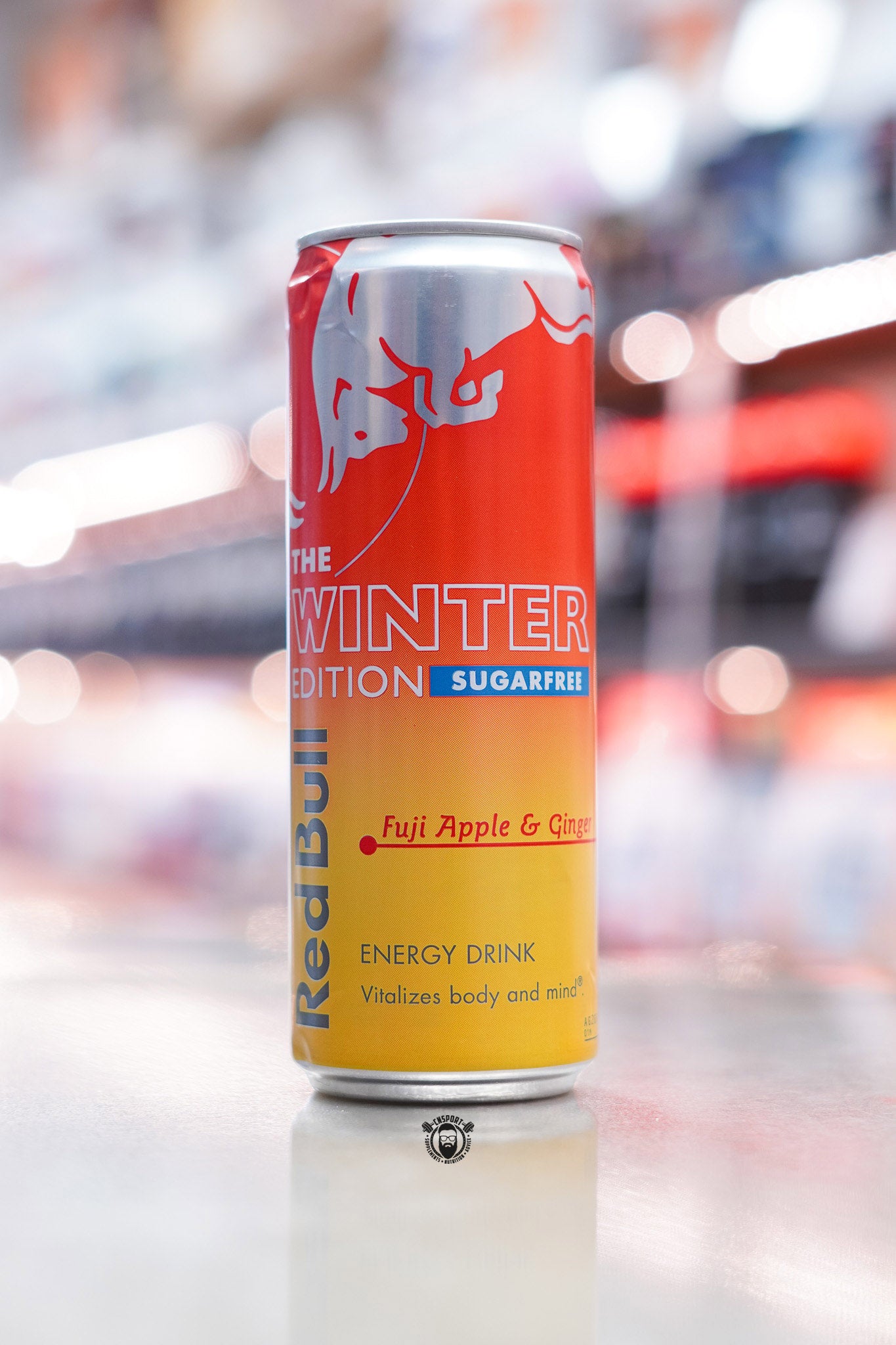 Front-facing image of Red Bull The Winter Edition Sugarfree 355ml can with red and yellow gradient design and “Fuji Apple & Ginger” flavour text.