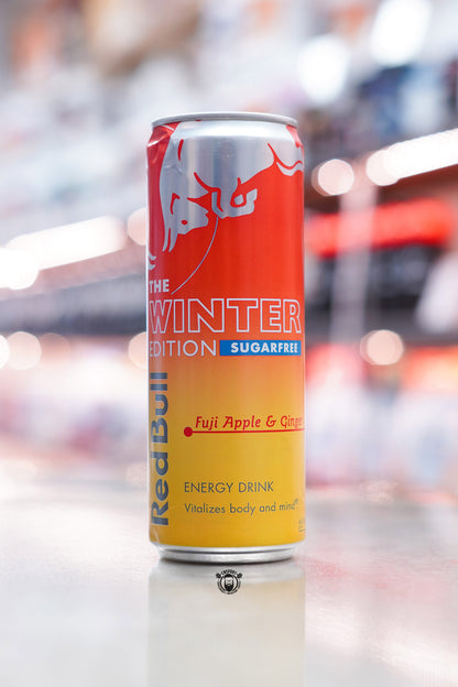 Front-facing image of Red Bull The Winter Edition Sugarfree 355ml can with red and yellow gradient design and “Fuji Apple & Ginger” flavour text.