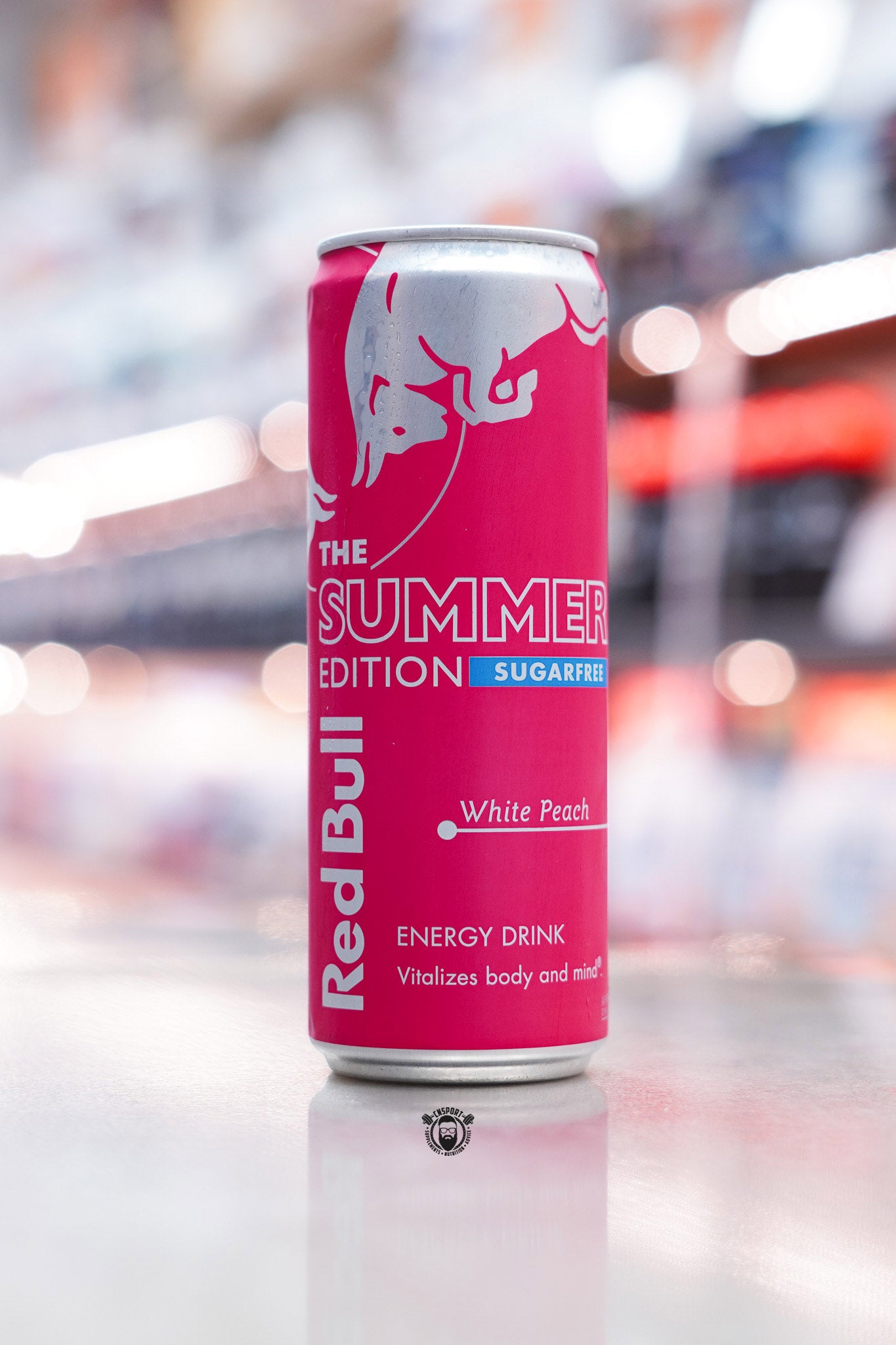 Front-facing image of Red Bull The Summer Edition Sugarfree 355ml can featuring bright pink design with silver bull logo and “White Peach” text.