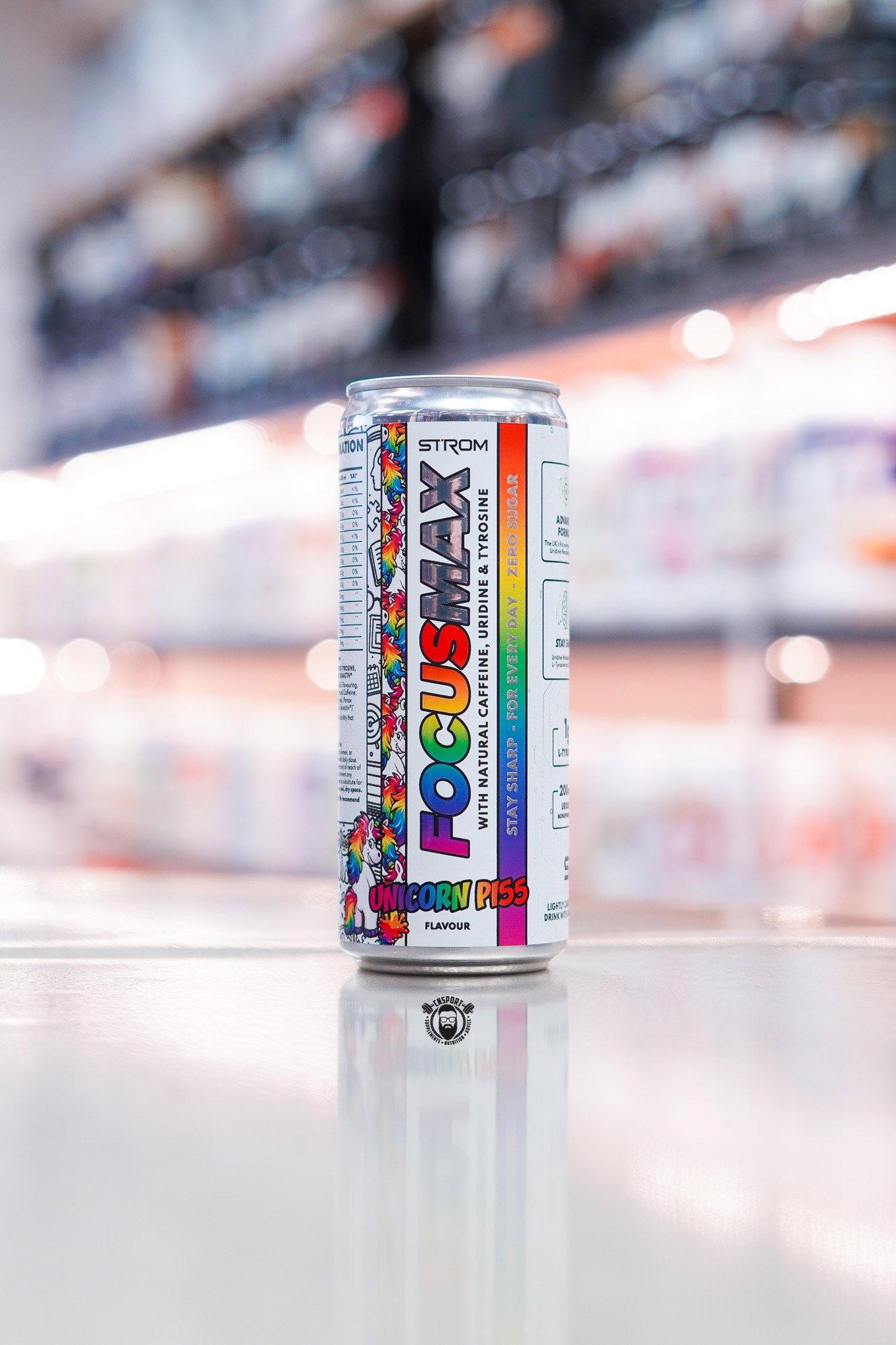 Strom FocusMax Unicorn Pi55 zero sugar energy drink can with natural caffeine, uridine and tyrosine on retail counter with blurred supplement store background