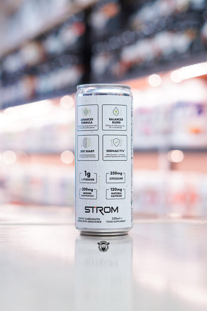 Side panel of Strom FocusMax 330ml energy drink can showing formula highlights including tyrosine, citicoline, uridine monophosphate and natural caffeine on retail counter with blurred supplement store background