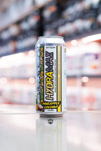 Strom HydraMax Pineapple Coconut hydration drink can made with real coconut water on retail counter with blurred supplement store background