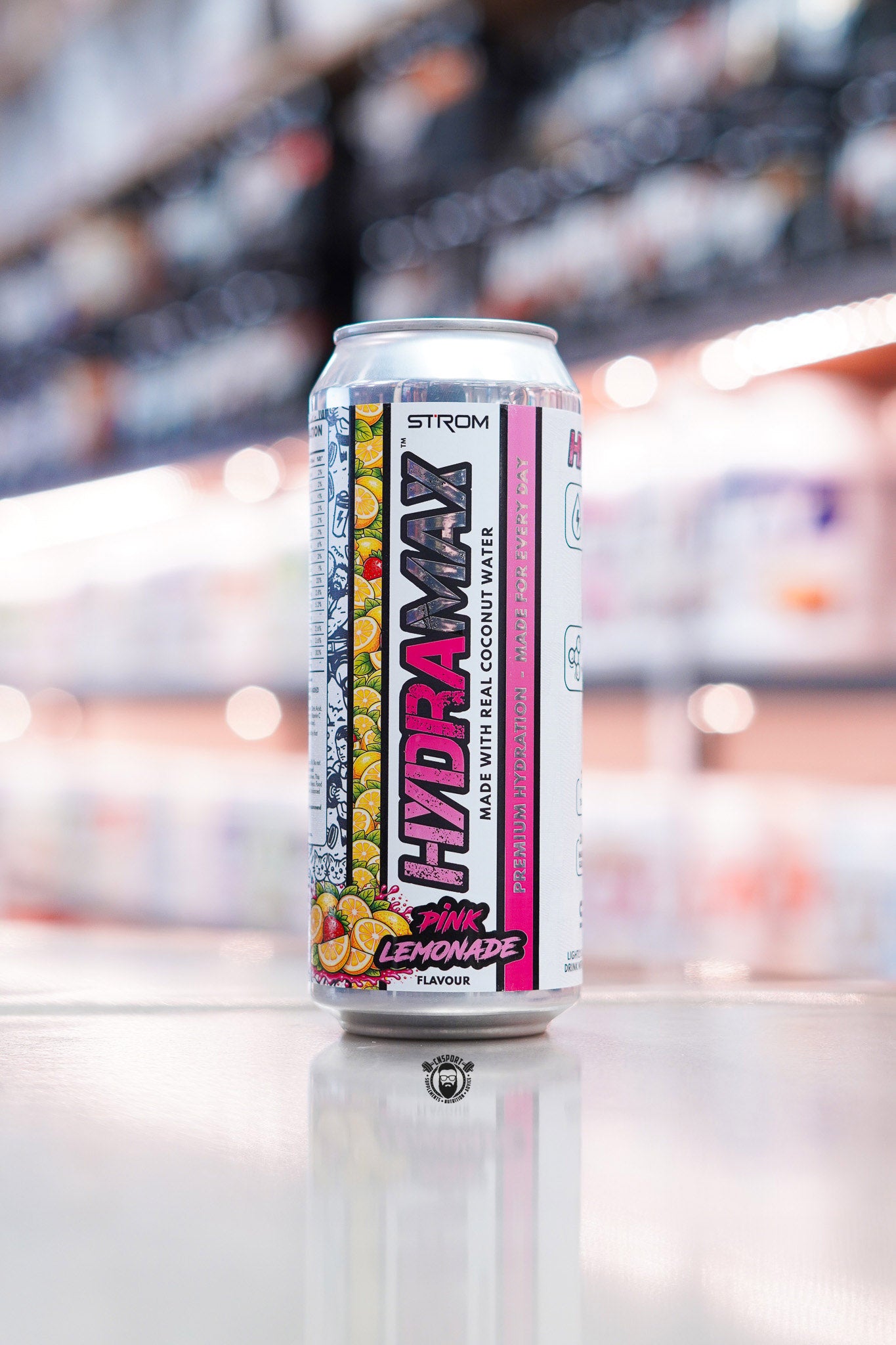 Strom HydraMax Pink Lemonade hydration drink can made with real coconut water on retail counter with blurred supplement store background