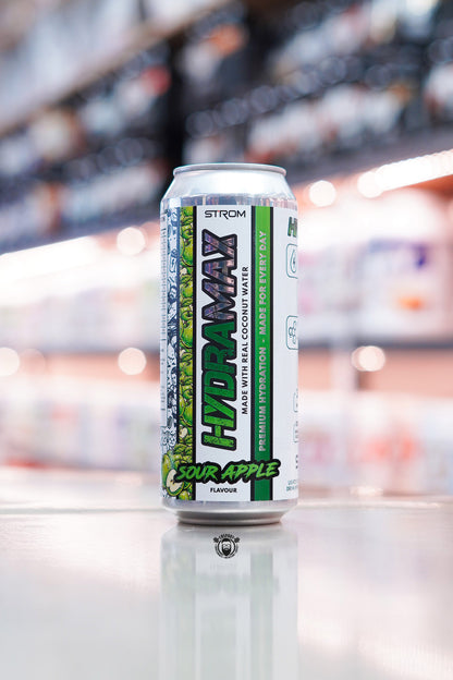 Strom HydraMax Sour Apple hydration drink can made with real coconut water on retail counter with blurred supplement store background