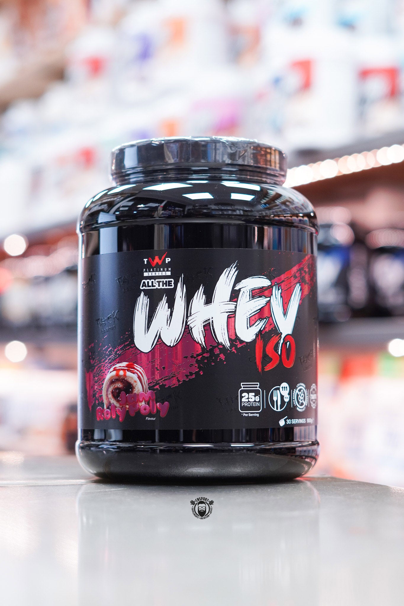 Front-facing image of TWP All The Whey Iso Jam Roly Poly flavour with vibrant red design, dessert image, and protein per serving callouts.