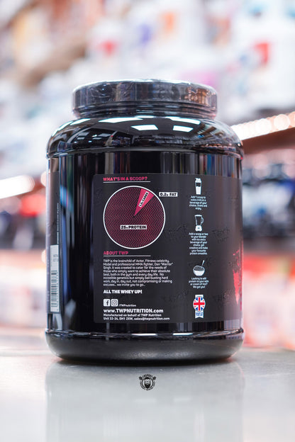 Side view of TWP All The Whey Iso Jam Roly Poly tub showing serving chart, brand story, and usage recommendations.