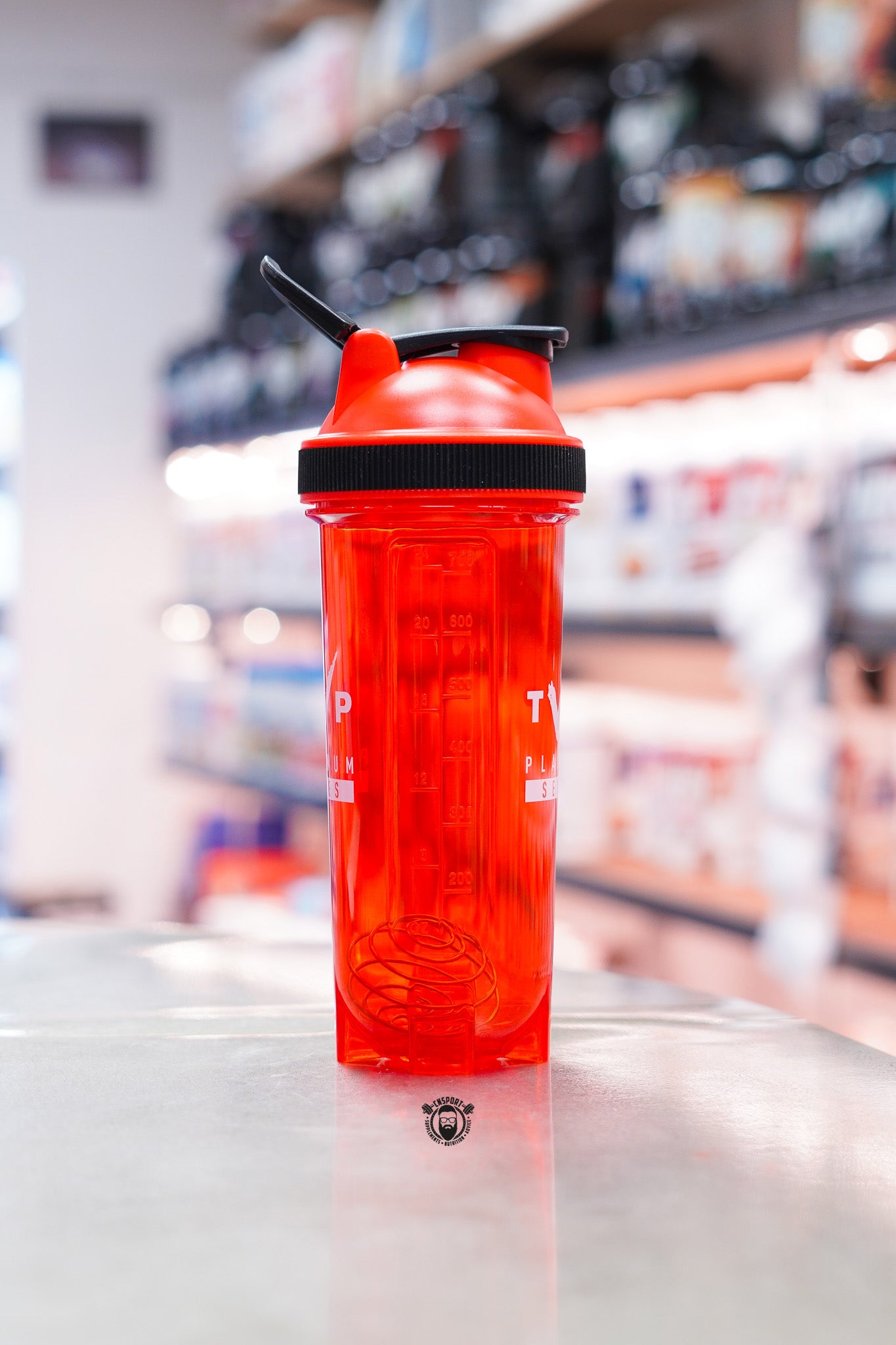 Side view of the TWP Platinum Series 800ml red shaker bottle showing the stainless steel blender whisk and volume markings.