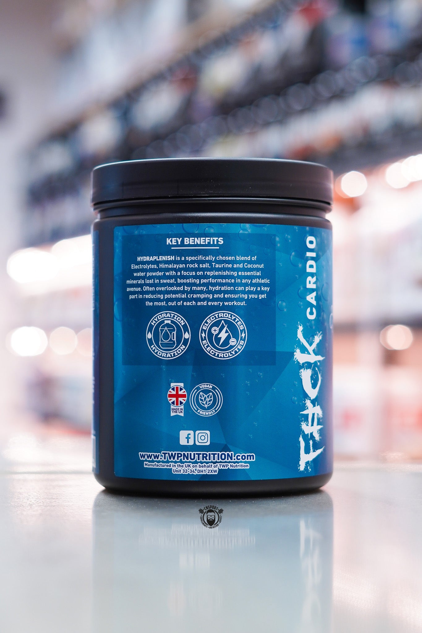 TWP Hydra Plenish hydration formula tub side view, Mango Passionfruit flavour, showing key benefits panel.