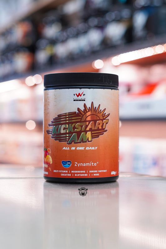 TWP KickStart AM all-in-one daily supplement, Orange Mango flavour, 30 servings, tub on supplement store counter.