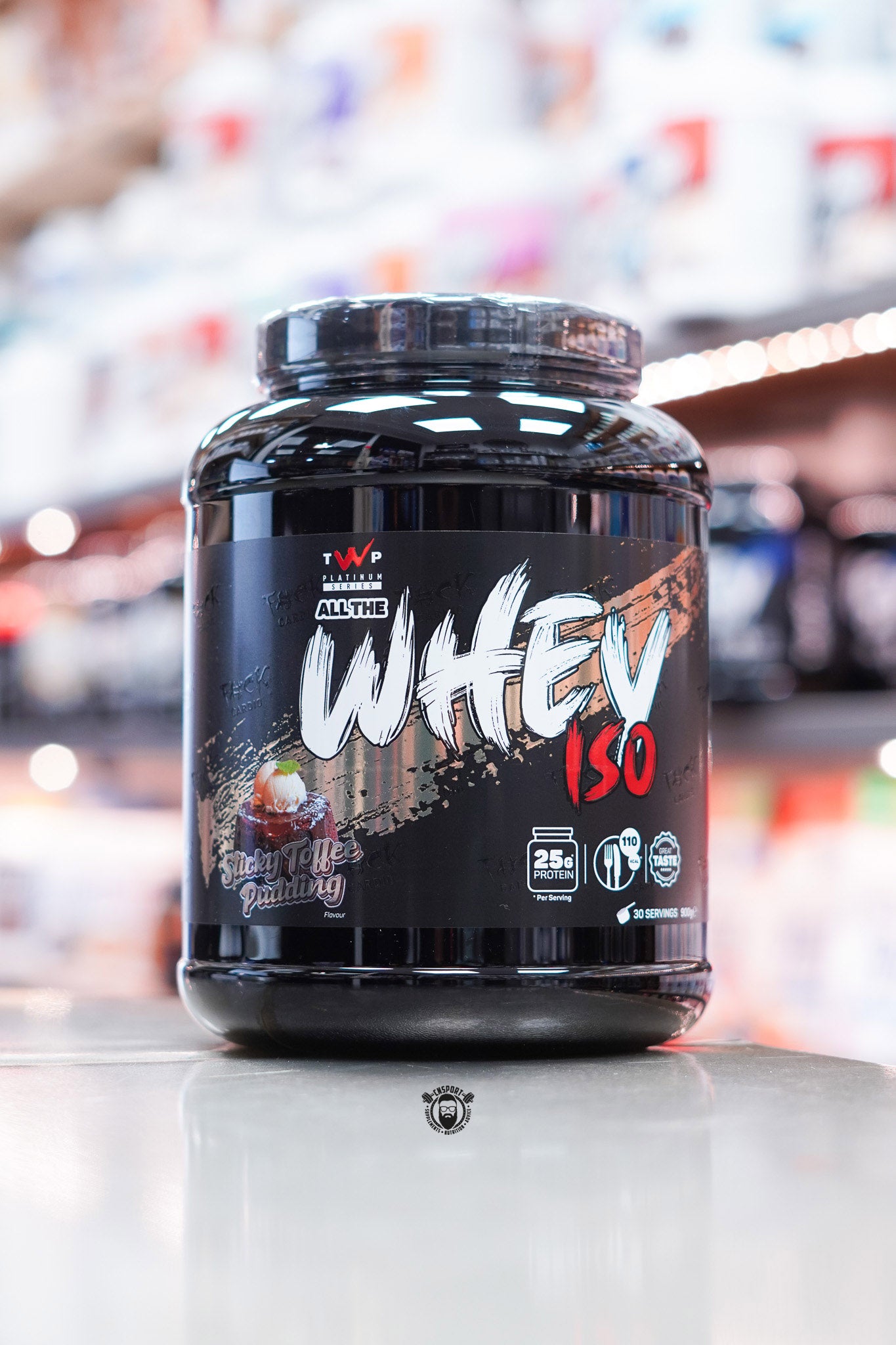 Front-facing image of TWP All The Whey Iso in Sticky Toffee Pudding flavour with a bold black label and dessert-themed graphics.