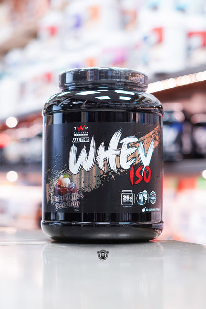 Front-facing image of TWP All The Whey Iso in Sticky Toffee Pudding flavour with a bold black label and dessert-themed graphics.