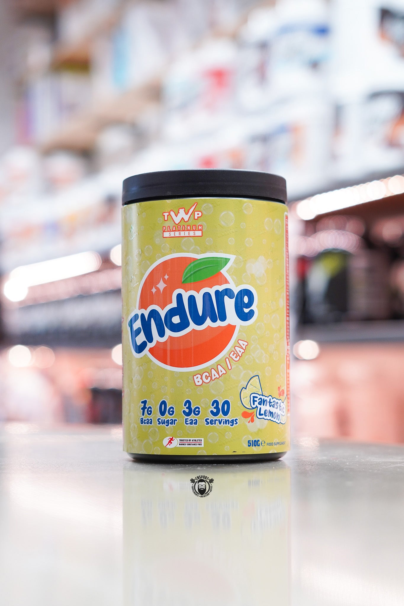 TWP Platinum Series Endure BCAA / EAA supplement, Fantastic Lemonade flavour, 510g tub, displayed on supplement store counter.