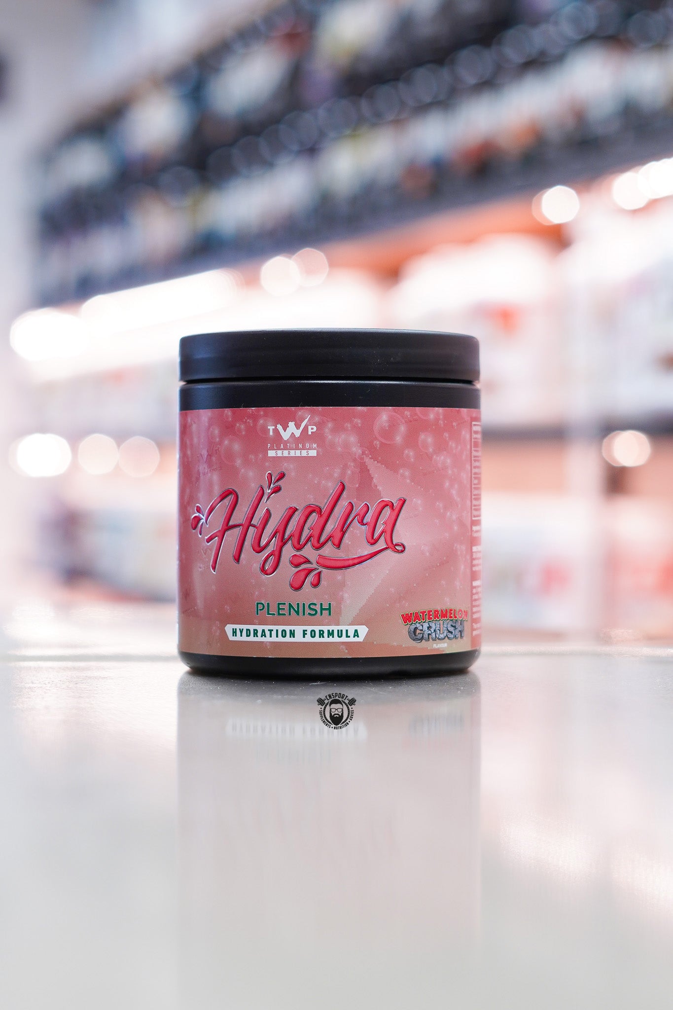 TWP Hydra Plenish hydration formula, Watermelon Crush flavour, 30 servings tub on supplement store counter.